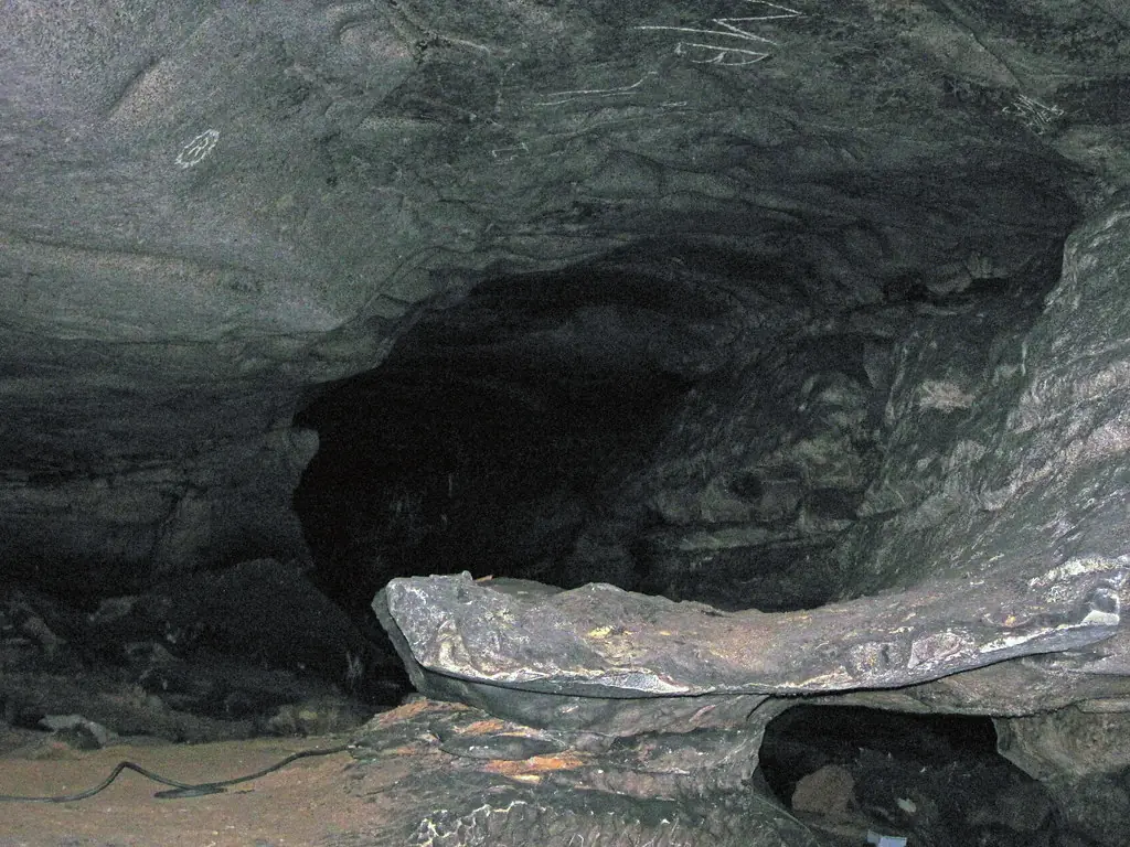 Natural limestone passage with a low ceiling, used as a real-world cave reference for the Level 8 Cave Systems guide